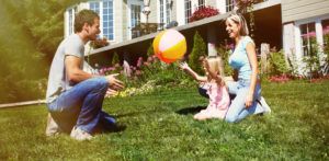 family playing on front lawn